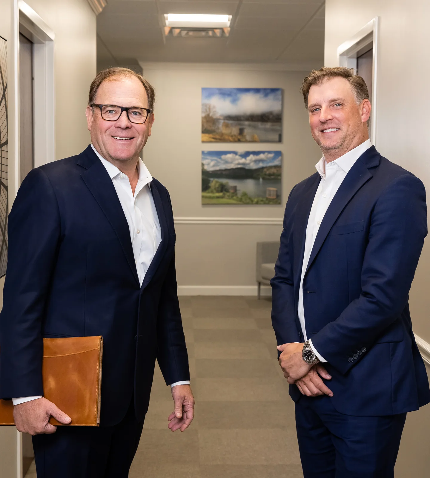 Scott Tabor and Ben Bailey, who brought their practices together in 2017, in the hallway of the TMB office