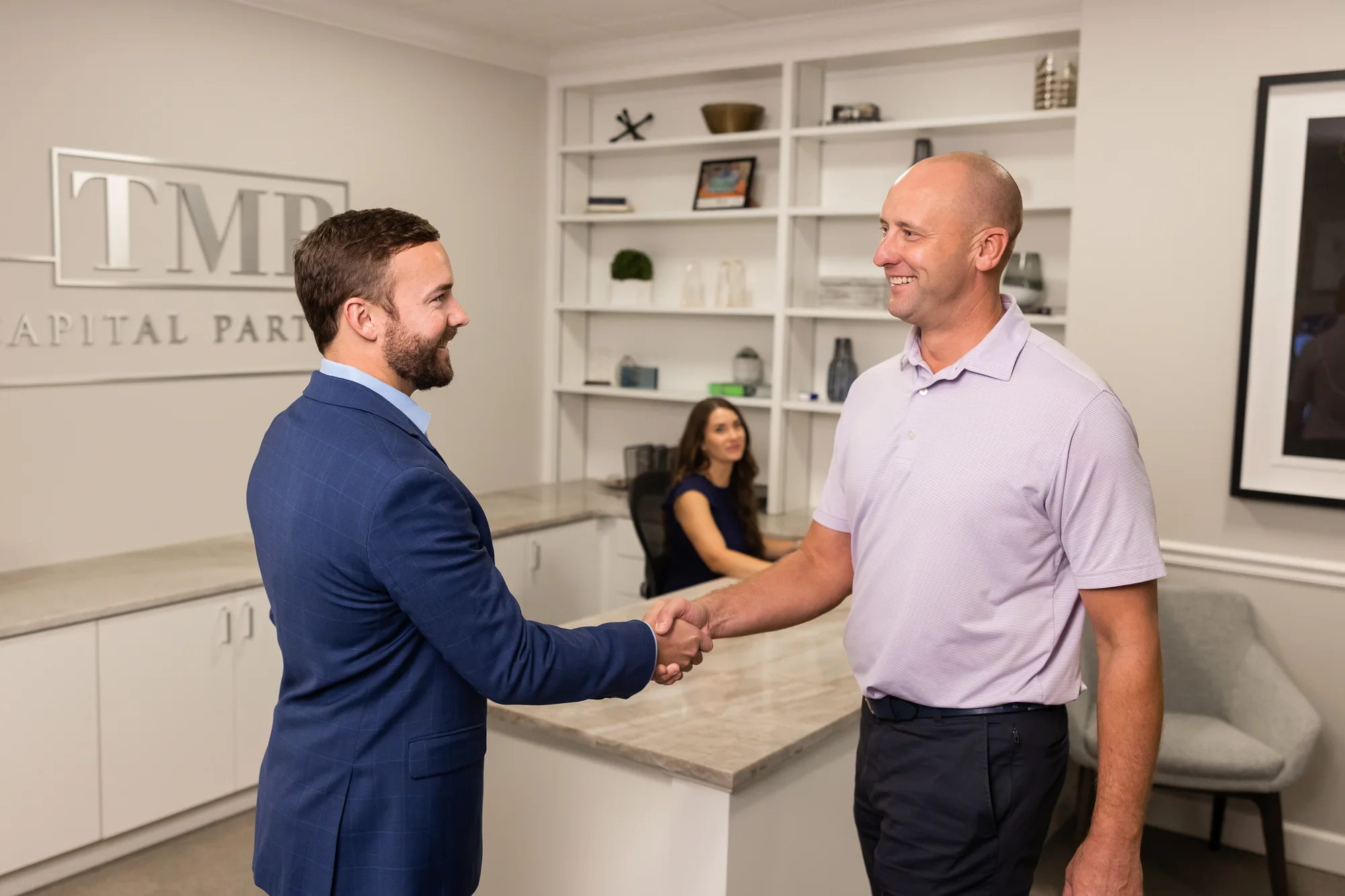 Zack Sokora shaking hands with a guest at TMB reception